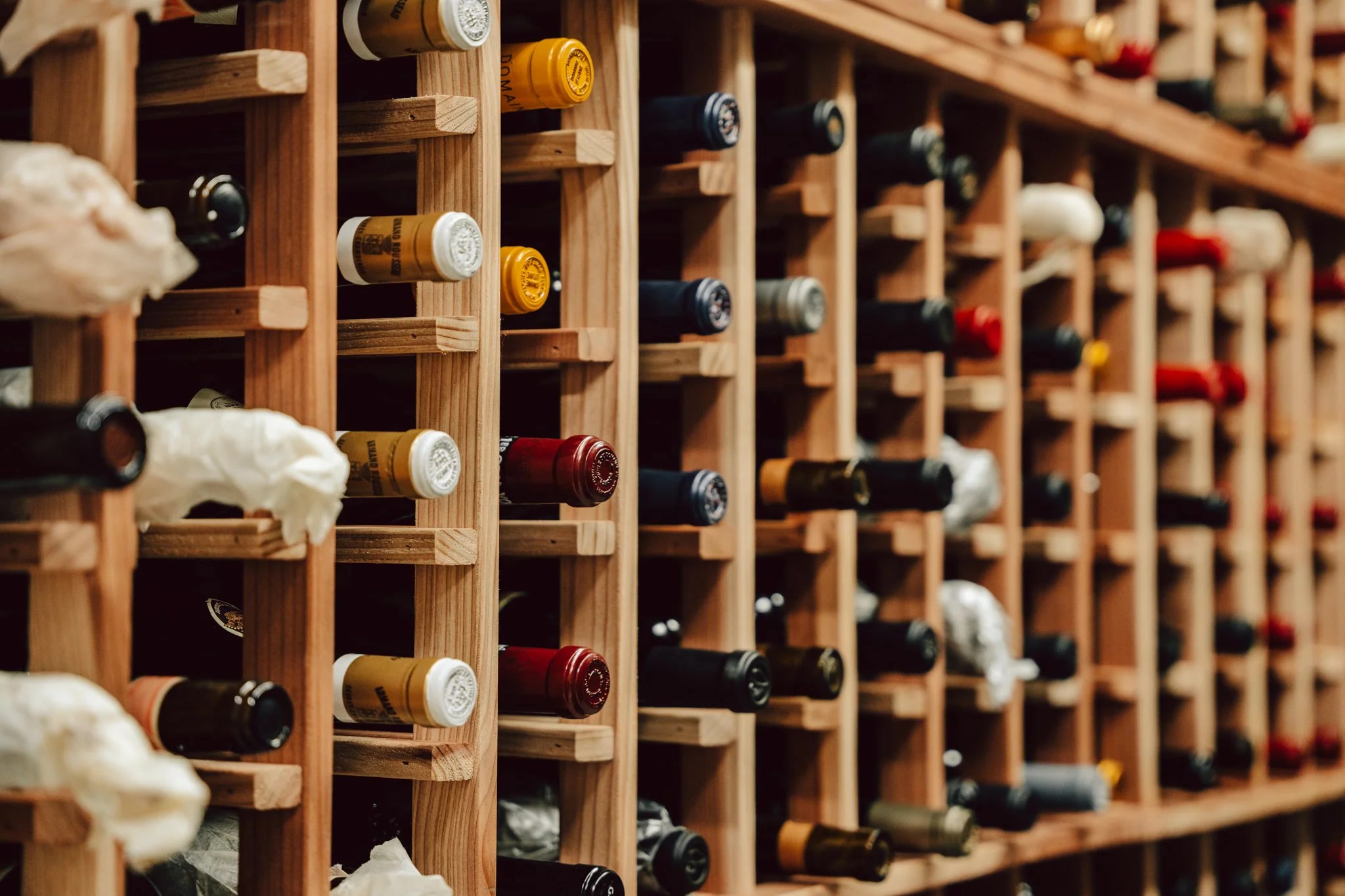 Wine bottles stored horizontally in wooden rack
